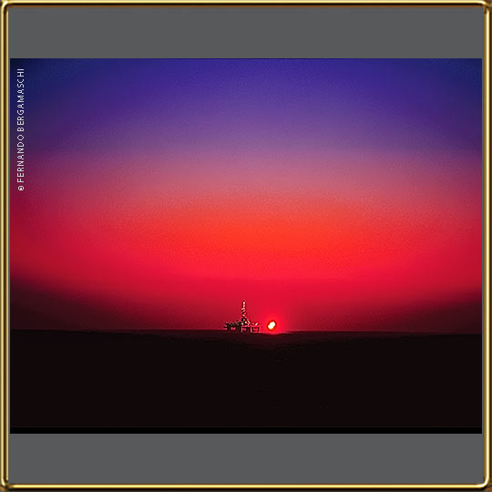 Offshore oil rig at sunrise in high sea